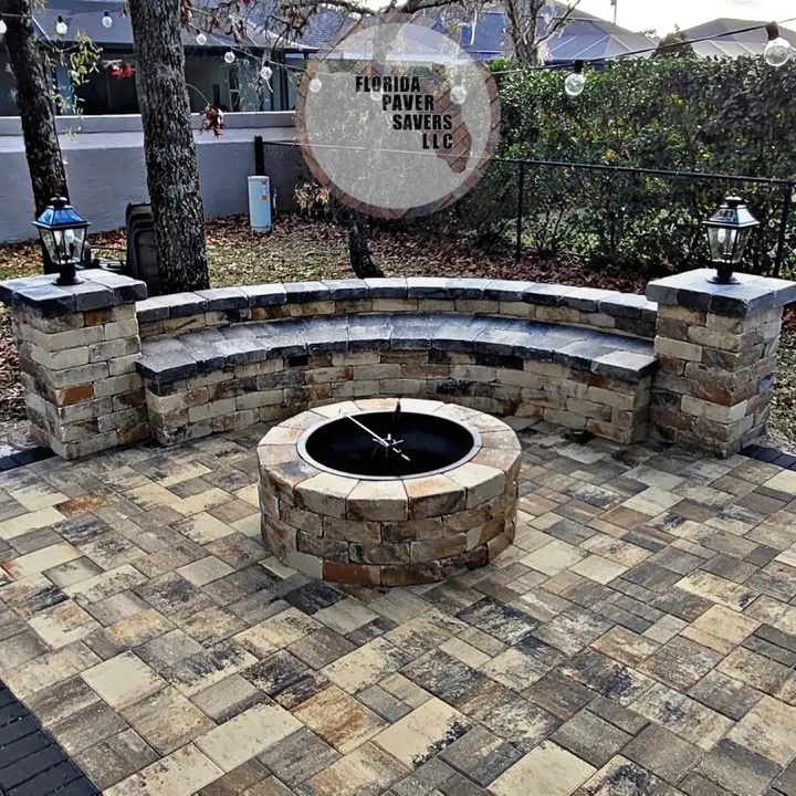 Circular fire pit with a curved seating wall and capped pillars