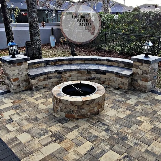 Circular fire pit with a curved seating wall and capped pillars