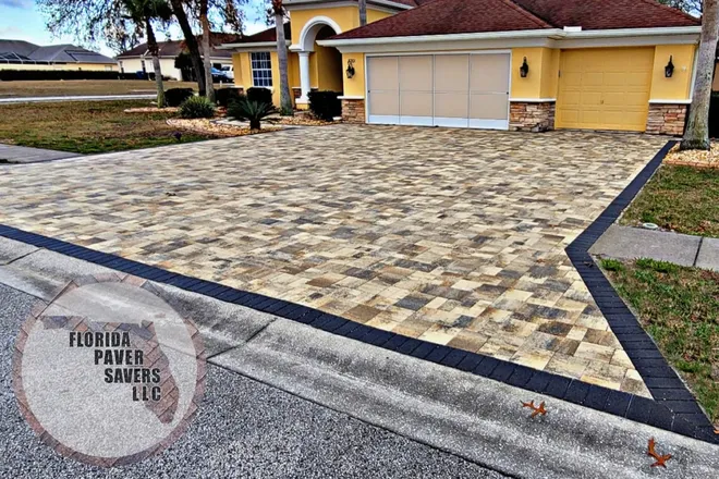 Custom paver driveway with a contrasting charcoal border