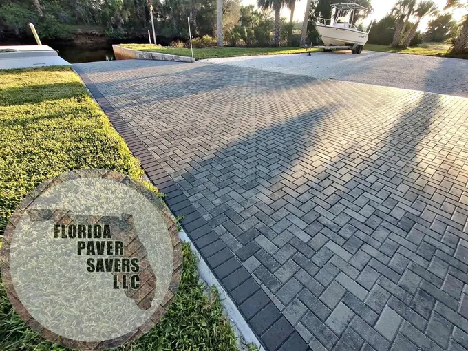Wide herringbone paver driveway with contrasting edge borders