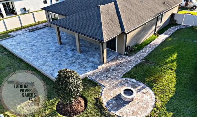 Aerial view of a paver patio and connecting path around a screened lanai