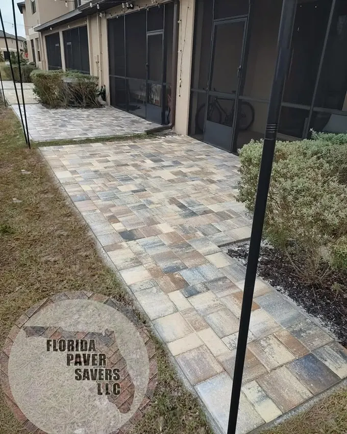 Narrow paver patio extension along the outside of a screened lanai