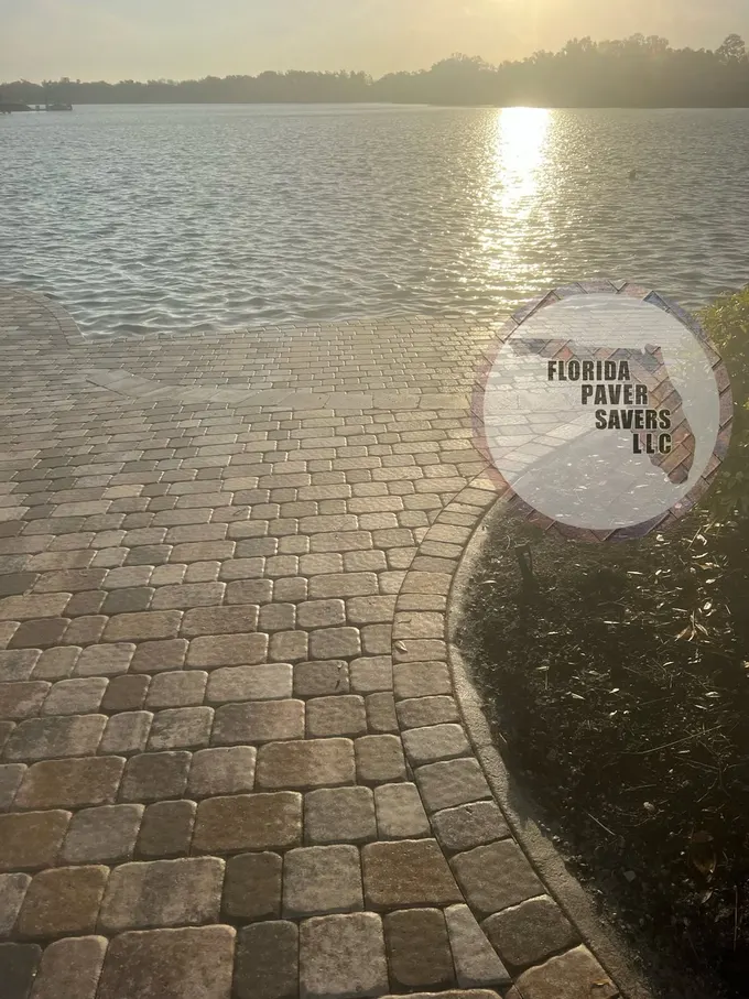 Curved waterfront paver patio catching the evening sunlight