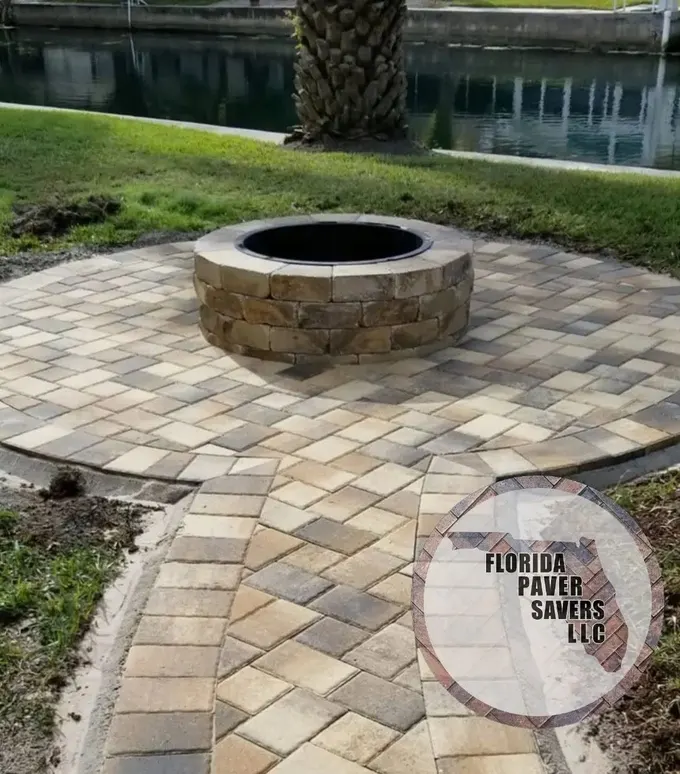 Circular paver fire pit area connected to a bordered garden path