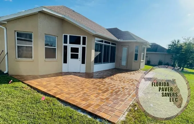 Warm multicolor paver patio wrapping around the rear of a home