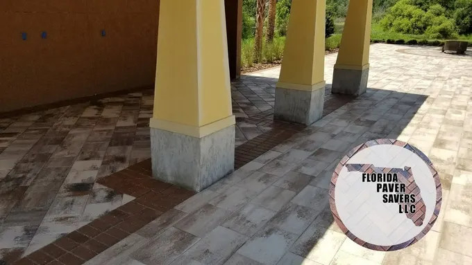 Commercial covered terrace with multicolor pavers around square columns