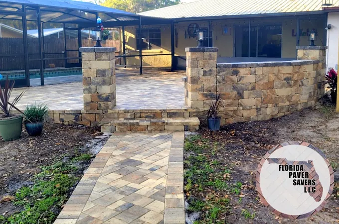 Paver patio and walkway with matching steps, a curved seating wall and capped columns in Floral City, Citrus County, Florida